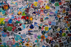 collaged stickers on a wall aesthetic