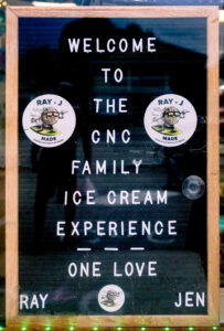 sign from CnC with text 'welcome to the cnc family ice cream experience - one love - Ray - Jen'