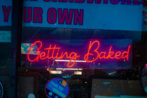 red neon sign reading 'Getting Baked'