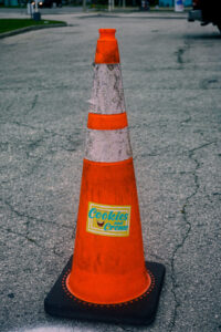 an orange traffic cone with a Cookies'n'Creme sticker